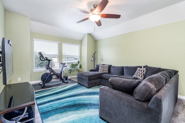 living area featuring visible vents, ceiling fan, baseboards, and lofted ceiling