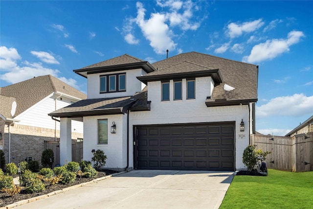 view of front facade featuring driveway, a shingled roof, fence, and a front yard