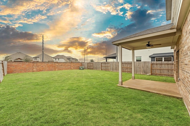 view of yard with a patio area, a fenced backyard, and ceiling fan