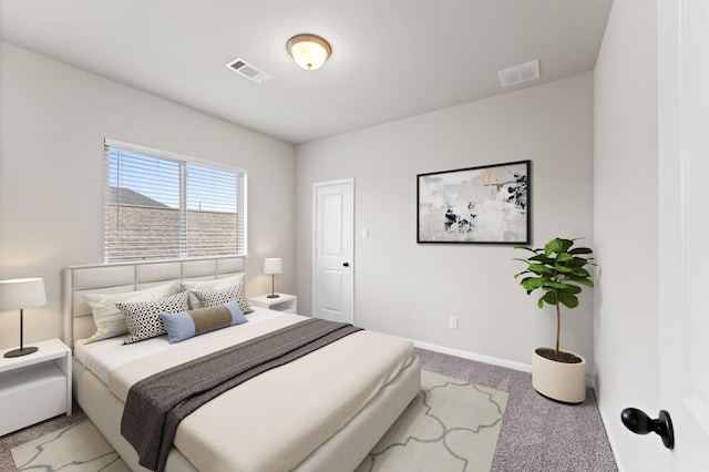 bedroom with baseboards, visible vents, and light colored carpet