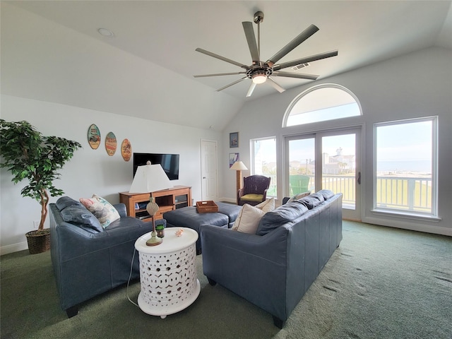 carpeted living room featuring baseboards, vaulted ceiling, and ceiling fan
