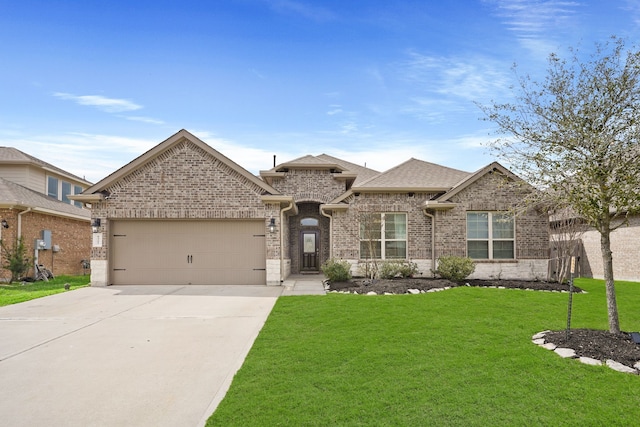 view of front of house with concrete driveway, roof with shingles, an attached garage, a front lawn, and brick siding