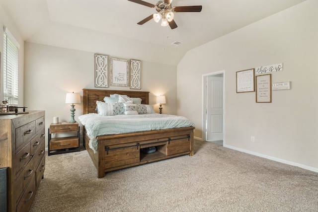 carpeted bedroom with visible vents, vaulted ceiling, baseboards, and ceiling fan