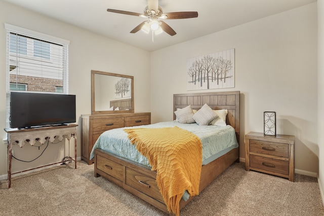 bedroom featuring a ceiling fan, light colored carpet, and baseboards