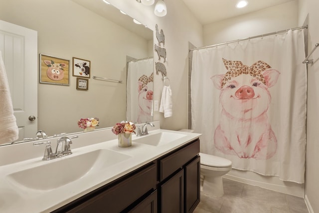 full bathroom with double vanity, a sink, toilet, and tile patterned floors