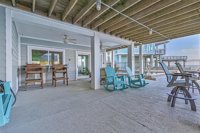 view of patio with a fenced in pool and ceiling fan