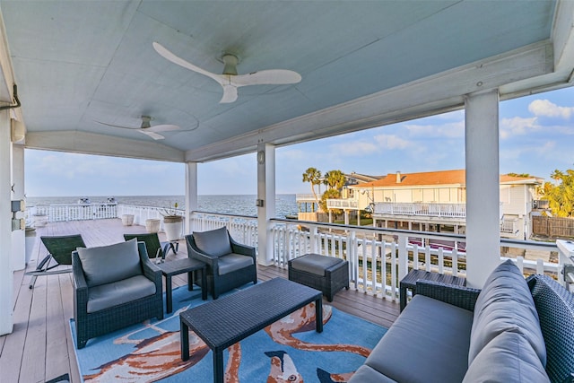 wooden deck with an outdoor hangout area, a water view, and a ceiling fan