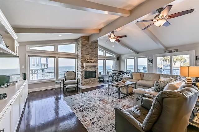 living room with baseboards, dark wood-style floors, a stone fireplace, high vaulted ceiling, and beam ceiling