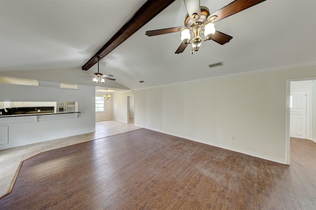 unfurnished living room featuring vaulted ceiling with beams, light wood finished floors, visible vents, and baseboards