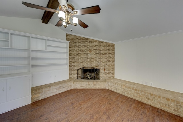 unfurnished living room featuring ceiling fan, wood finished floors, vaulted ceiling with beams, crown molding, and a fireplace