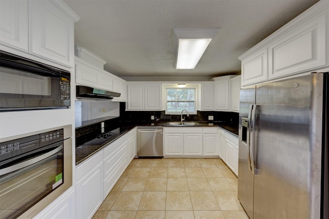 kitchen featuring black appliances, dark countertops, a sink, and under cabinet range hood