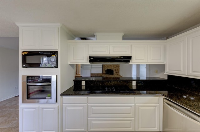 kitchen featuring black appliances, dark stone countertops, white cabinetry, and under cabinet range hood