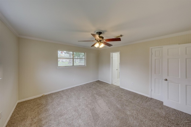 unfurnished bedroom featuring carpet floors, ornamental molding, visible vents, and baseboards