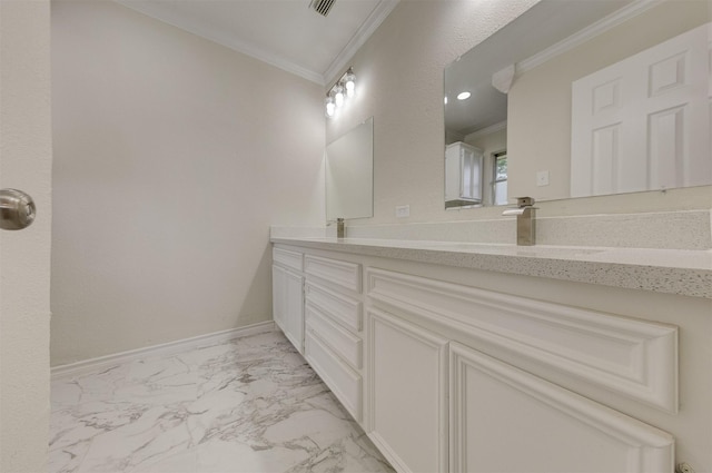 full bath featuring marble finish floor, crown molding, double vanity, a sink, and baseboards