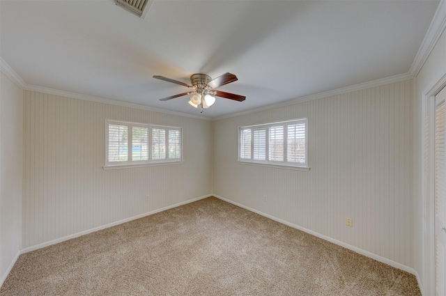 spare room with ornamental molding, carpet, and visible vents