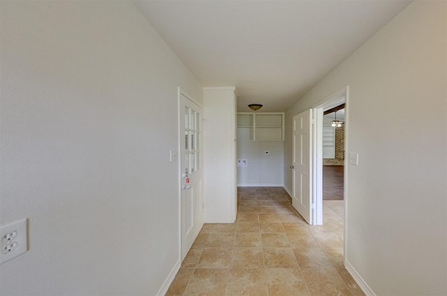 hallway featuring baseboards