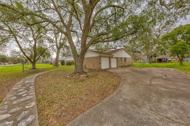 view of front of property with a garage, concrete driveway, brick siding, and a front lawn