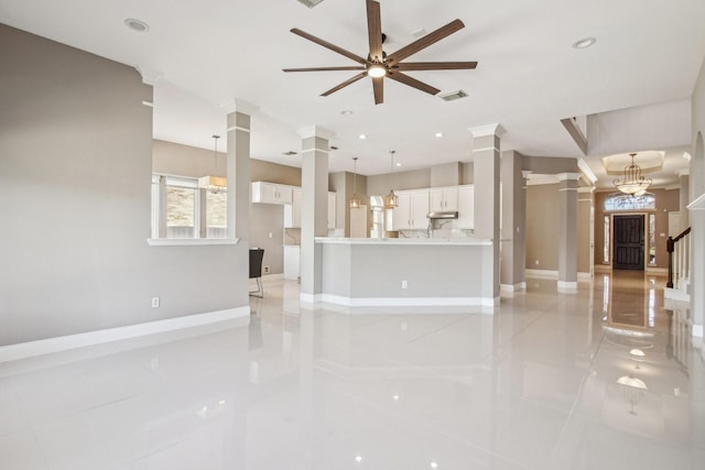 unfurnished living room featuring recessed lighting, visible vents, and ornate columns