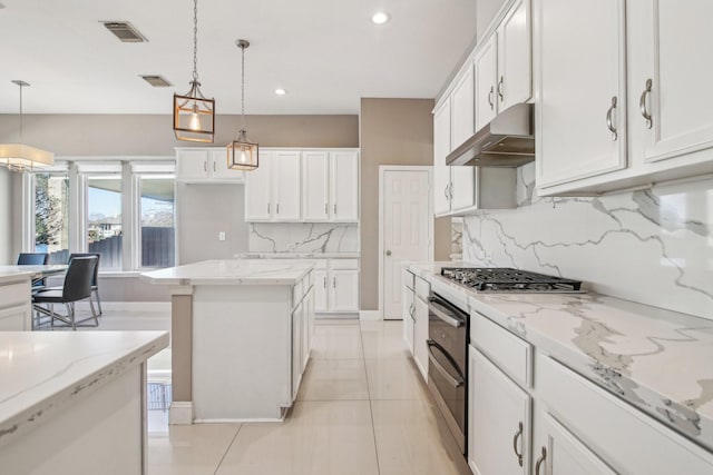 kitchen featuring white cabinetry, ventilation hood, visible vents, and range with two ovens