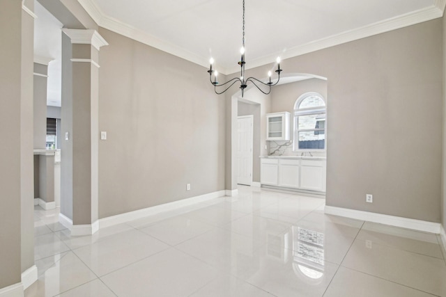 unfurnished dining area with a notable chandelier, light tile patterned flooring, baseboards, and ornamental molding