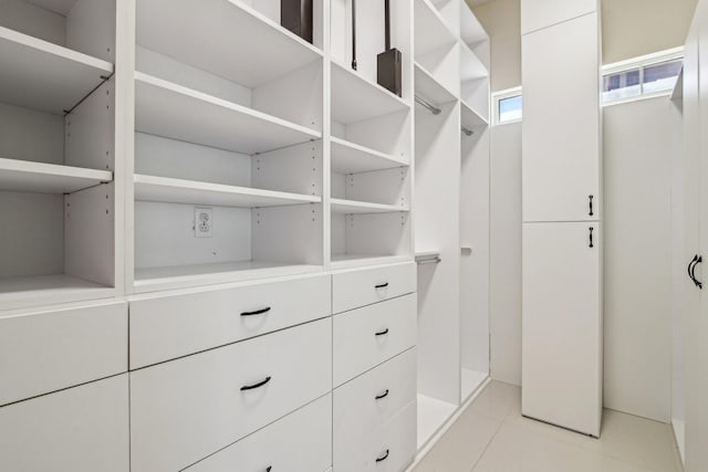 spacious closet with light tile patterned floors