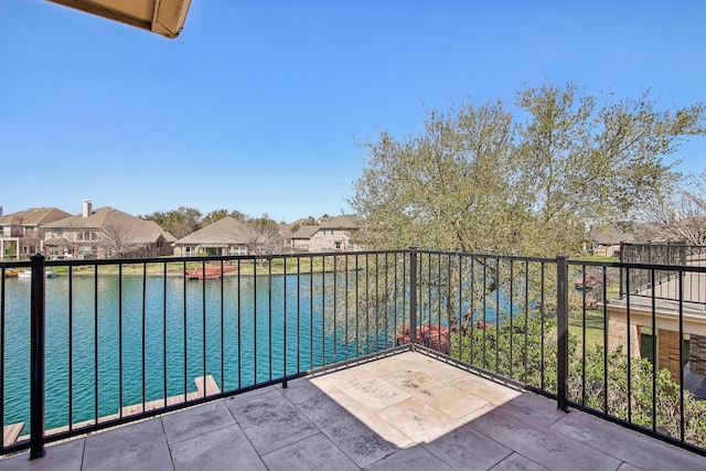 balcony featuring a residential view and a water view