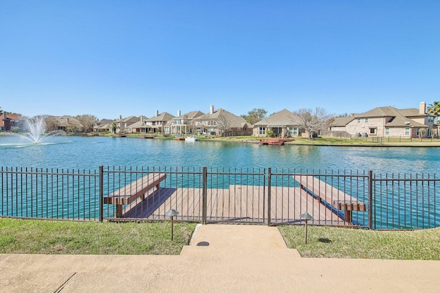 dock area with a residential view and a water view