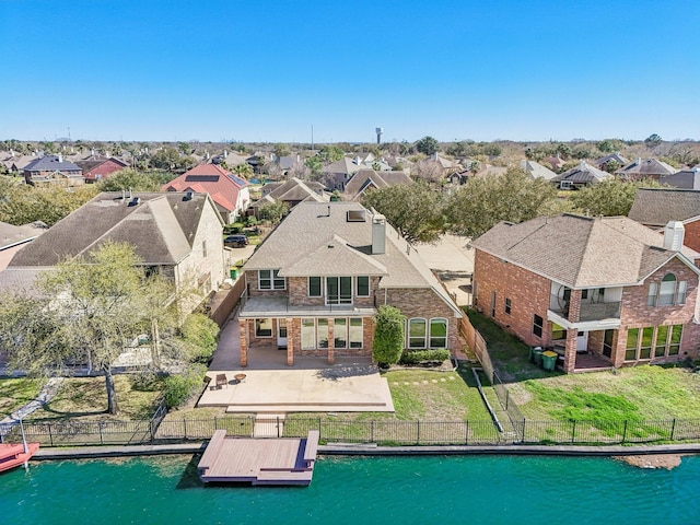 birds eye view of property featuring a residential view and a water view