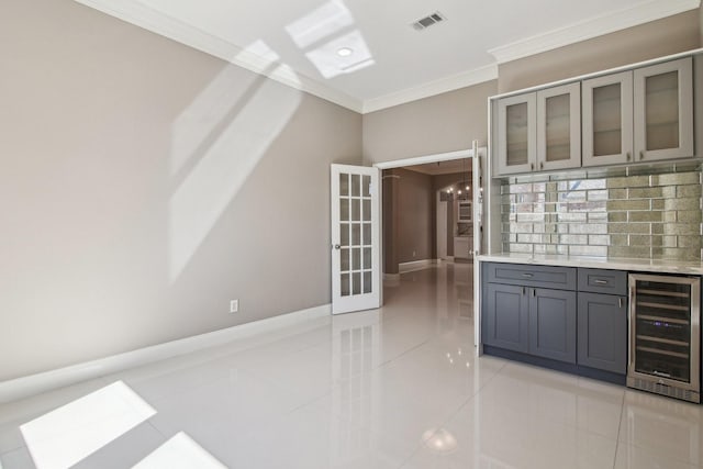 kitchen featuring visible vents, gray cabinets, backsplash, wine cooler, and light tile patterned flooring