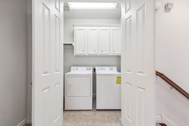 laundry area with visible vents, separate washer and dryer, light tile patterned flooring, and cabinet space