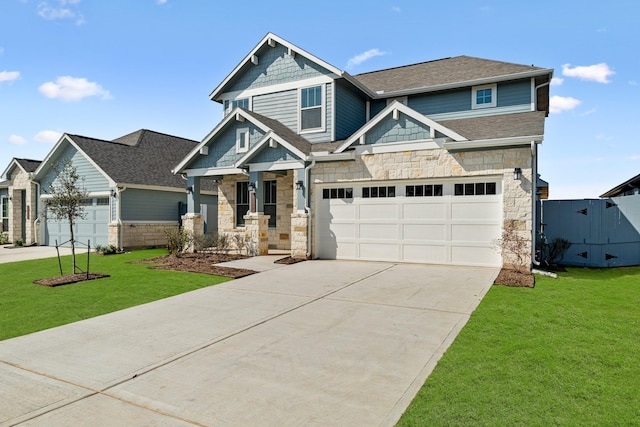 craftsman inspired home featuring concrete driveway, roof with shingles, and a front lawn