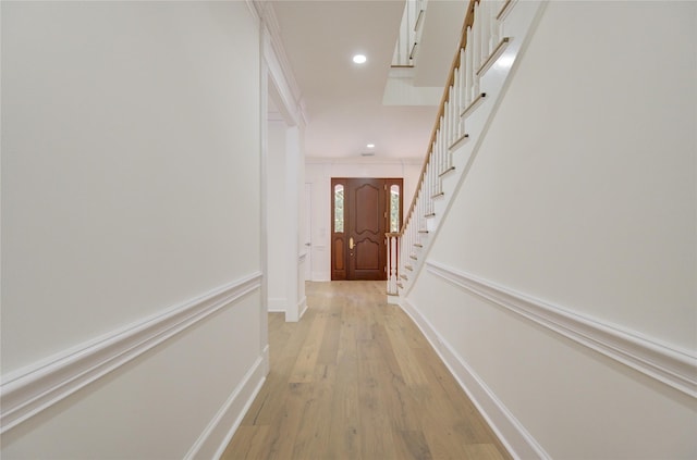 hall with stairs, baseboards, light wood-style flooring, and recessed lighting