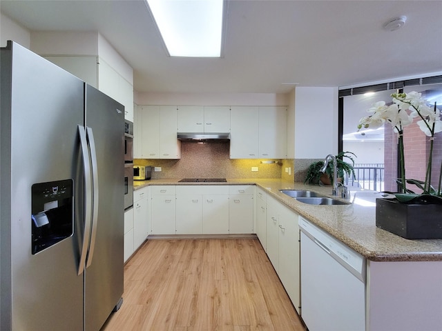 kitchen with stainless steel refrigerator with ice dispenser, a sink, dishwasher, under cabinet range hood, and black electric cooktop