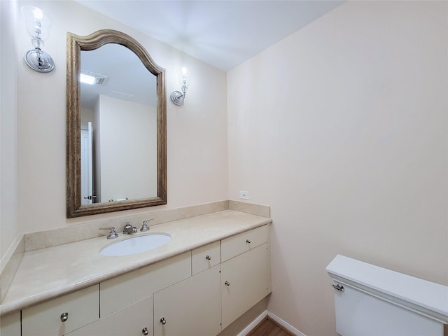 bathroom featuring toilet and vanity