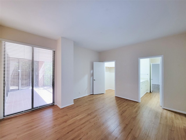 unfurnished room with light wood finished floors and baseboards