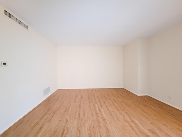 spare room with visible vents and wood finished floors