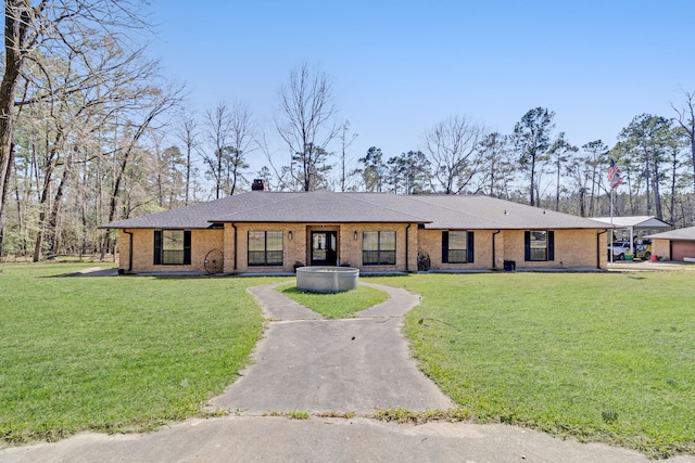 single story home with brick siding, a chimney, a front lawn, and roof with shingles