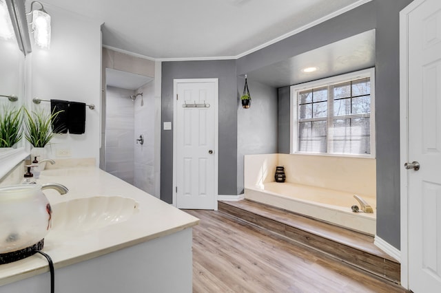 bathroom featuring tiled shower, a sink, a garden tub, and wood finished floors