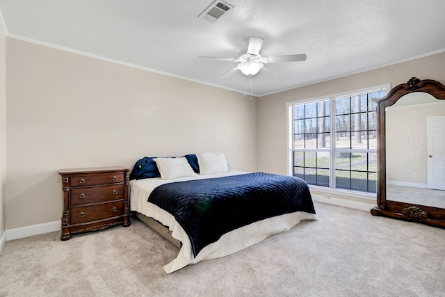 bedroom with carpet floors, visible vents, ornamental molding, and baseboards