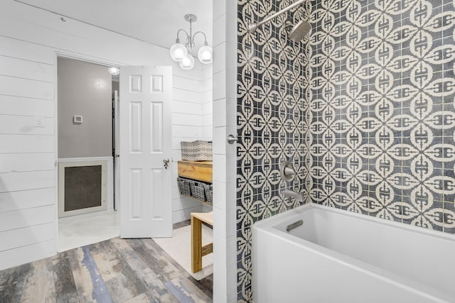 full bath featuring bathtub / shower combination, wood walls, wood finished floors, and visible vents