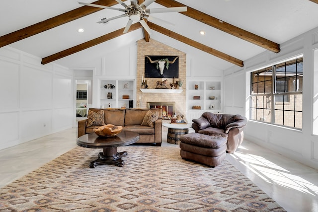 living area featuring a decorative wall, a ceiling fan, built in features, and a brick fireplace