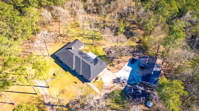 birds eye view of property featuring a view of trees