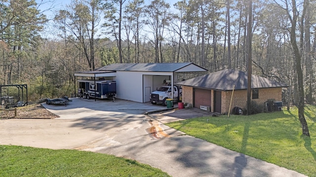 view of outbuilding with a wooded view and an outdoor structure