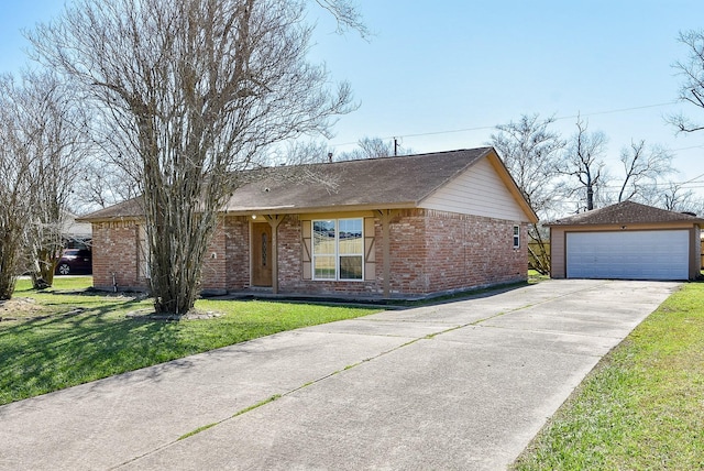 single story home with a garage, a front yard, brick siding, and an outdoor structure