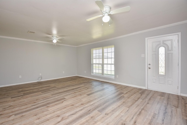 entryway with baseboards, visible vents, wood finished floors, and ornamental molding