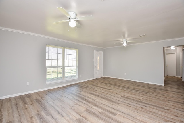 unfurnished room with ornamental molding, a ceiling fan, baseboards, and wood finished floors