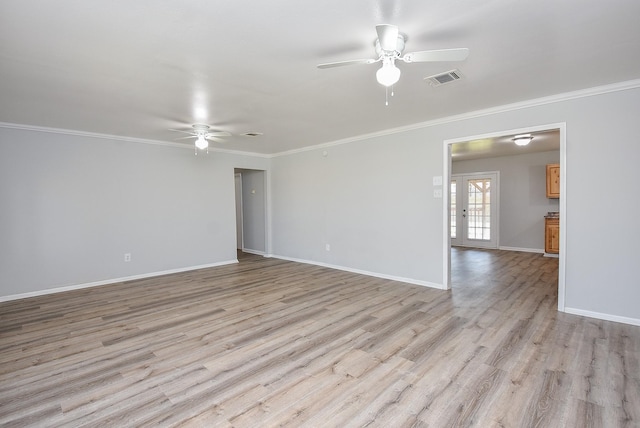 empty room featuring visible vents, light wood-style floors, ornamental molding, a ceiling fan, and baseboards