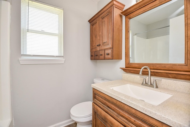 full bathroom with vanity, toilet, and baseboards