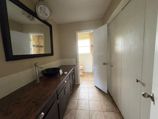 full bathroom featuring toilet, vanity, and tile patterned floors