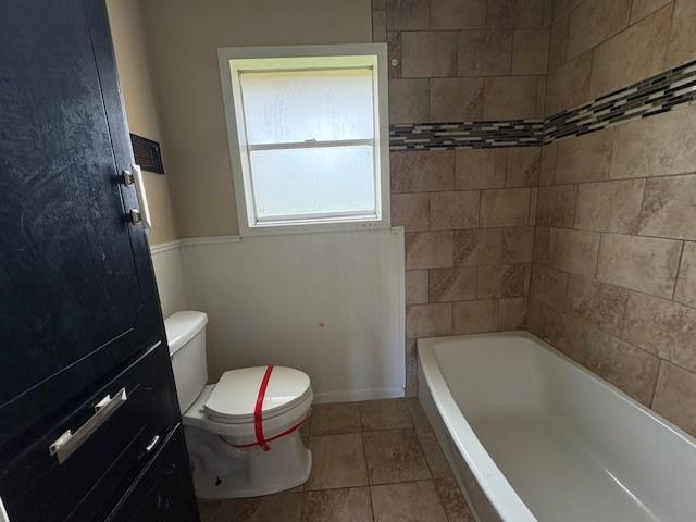 bathroom featuring tile patterned flooring and toilet